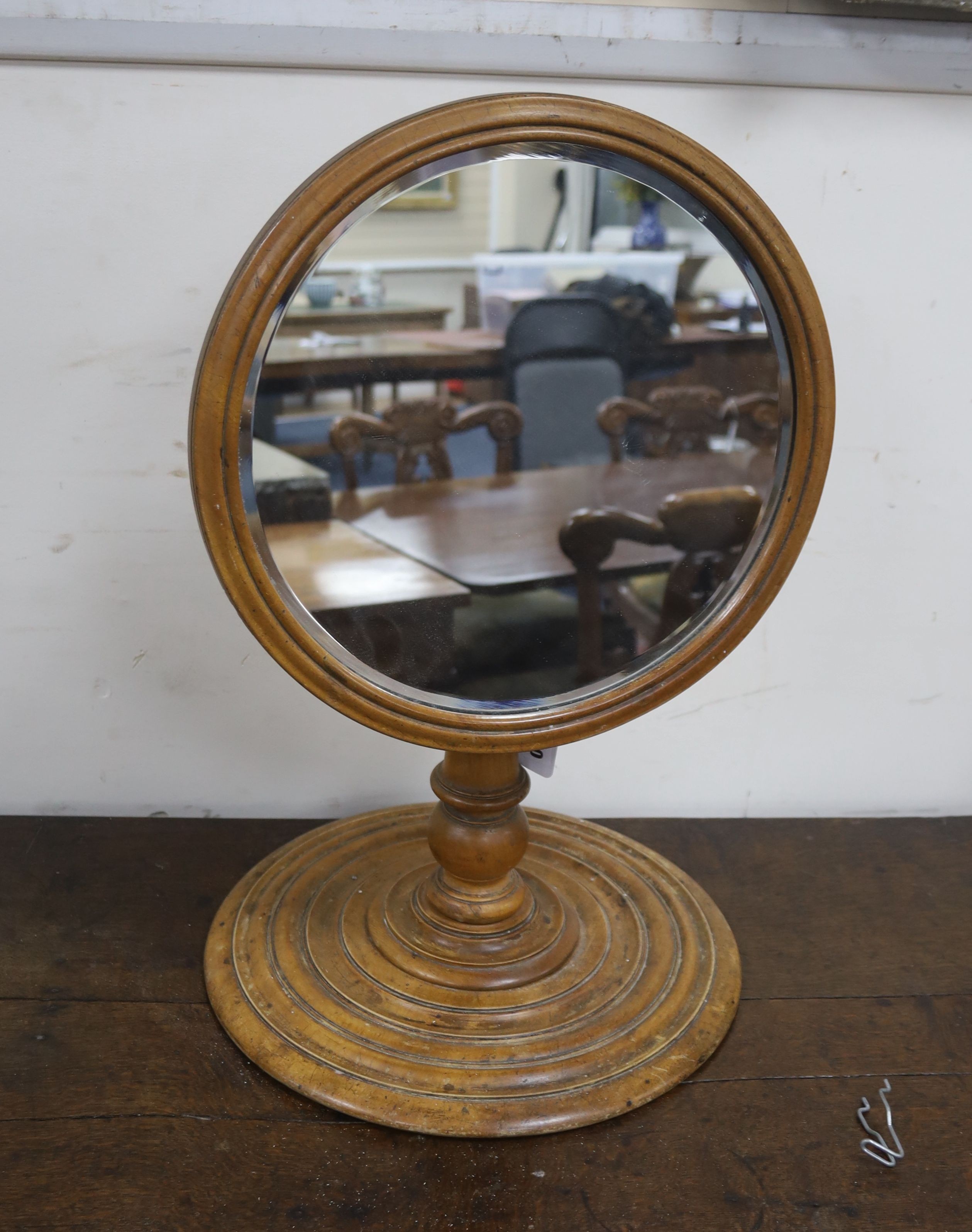 A Victorian gentleman’s telescopic walnut shaving mirror, with a stepped circular base, plate diameter 34cm, height 56cm